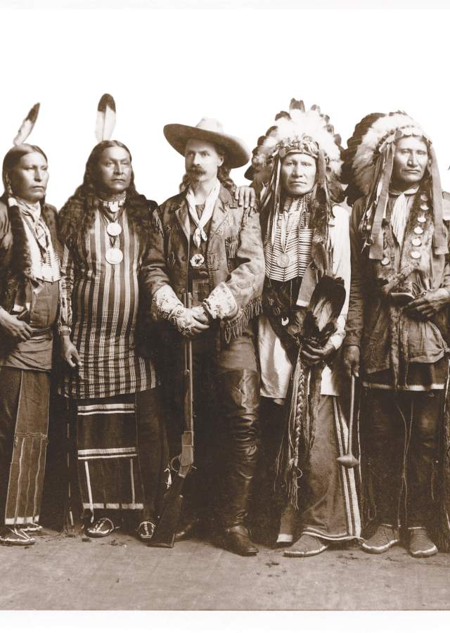Historic photo of Buffalo Bill Cody and a group of Native Americans.
