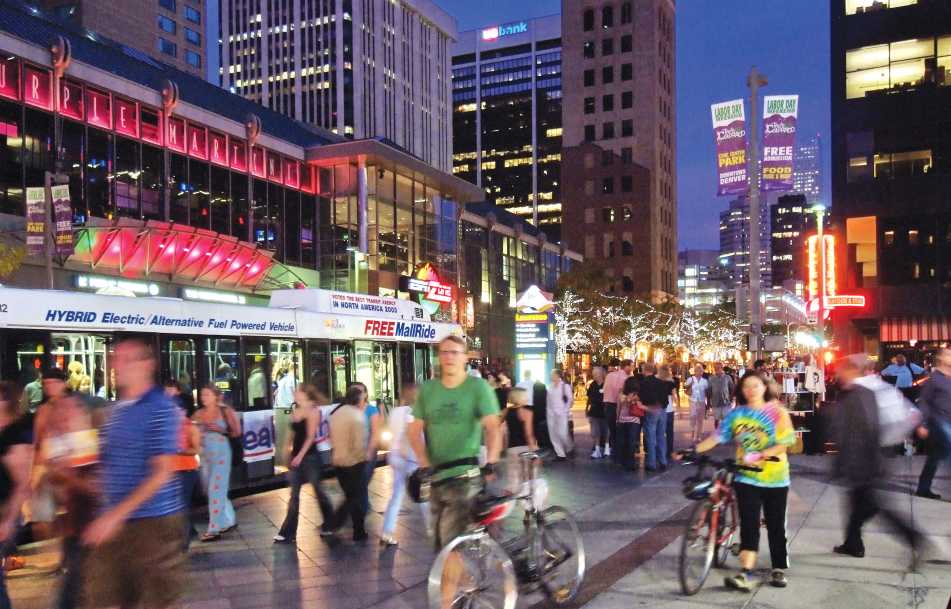 Pedestrians enjoy shops, restaurants, entertainment venues, and the Free Mall Ride on the 16th Street Mall.