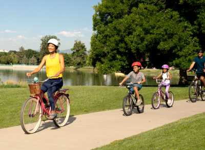 Family riding bikes on Denver bike trail