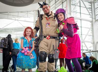 A father and his two daughters in costumes at FAN EXPO DENVER