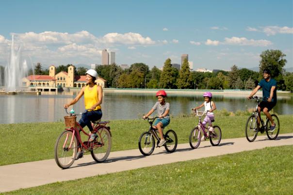 A family bike riding in a Denver park.