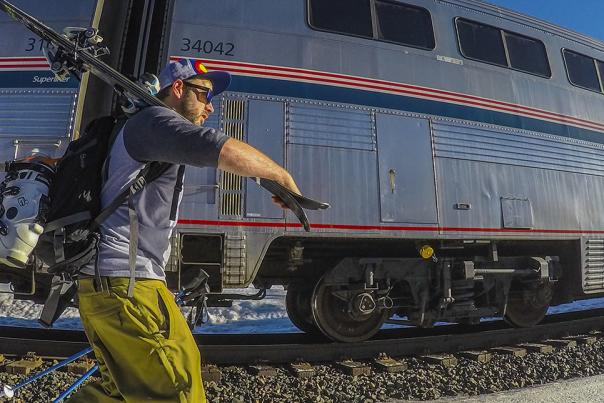 Skier walking from Winter Park Express Ski Train